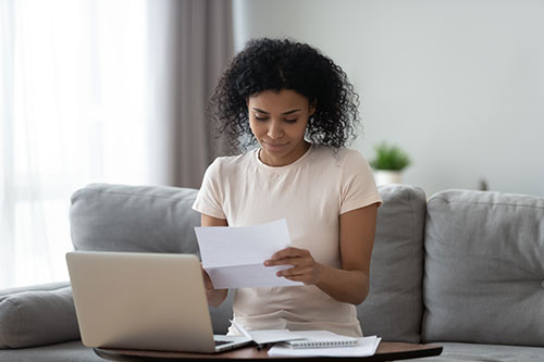 woman looking at financial papers
