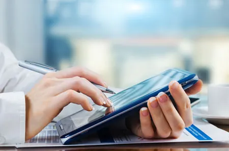 person using a tablet to fill out registration information